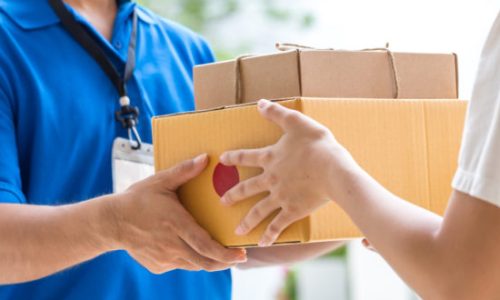 Woman hand accepting a delivery of boxes from deliveryman